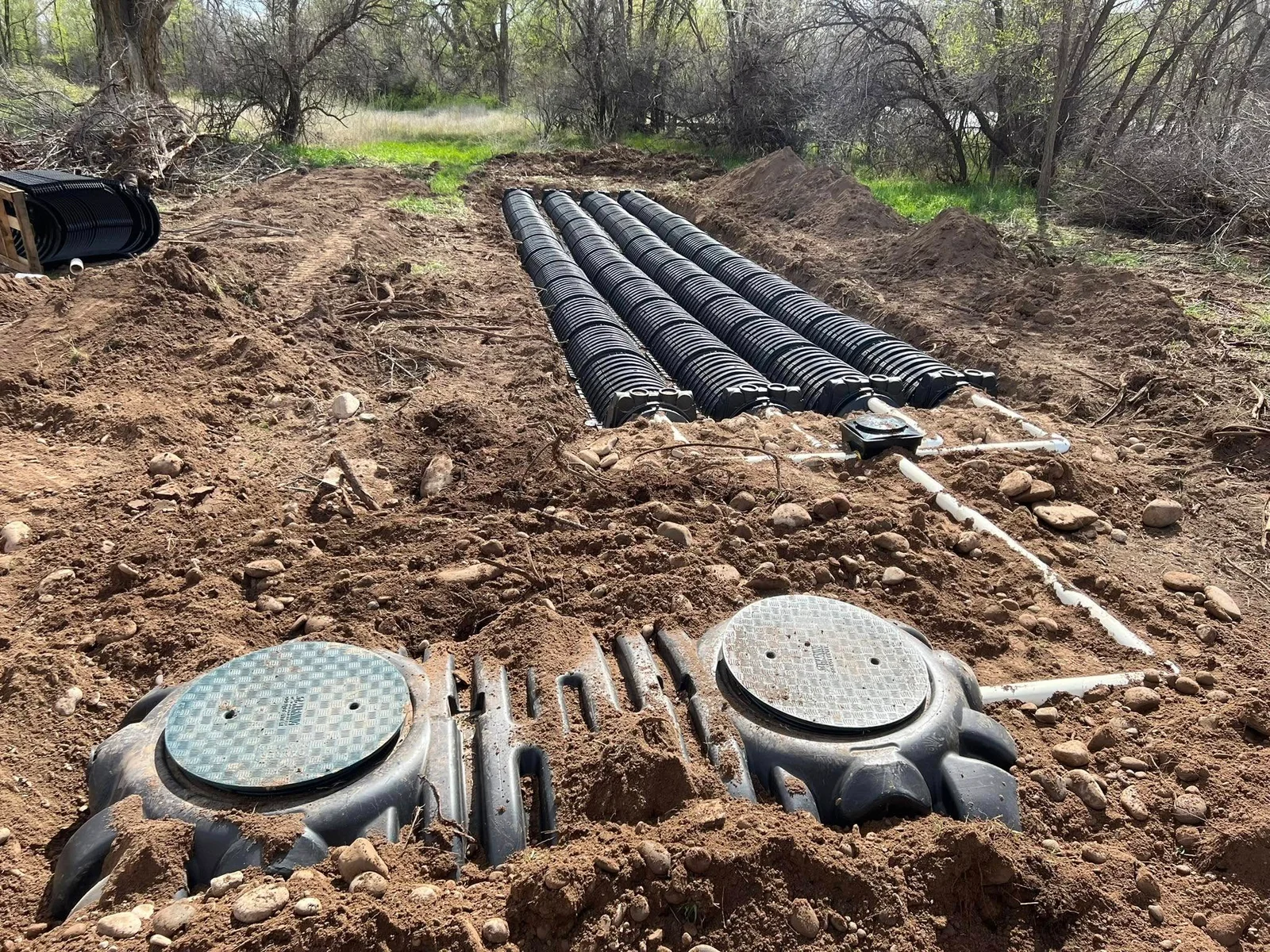 Septic system with tanks and rows of drainage chambers during installation