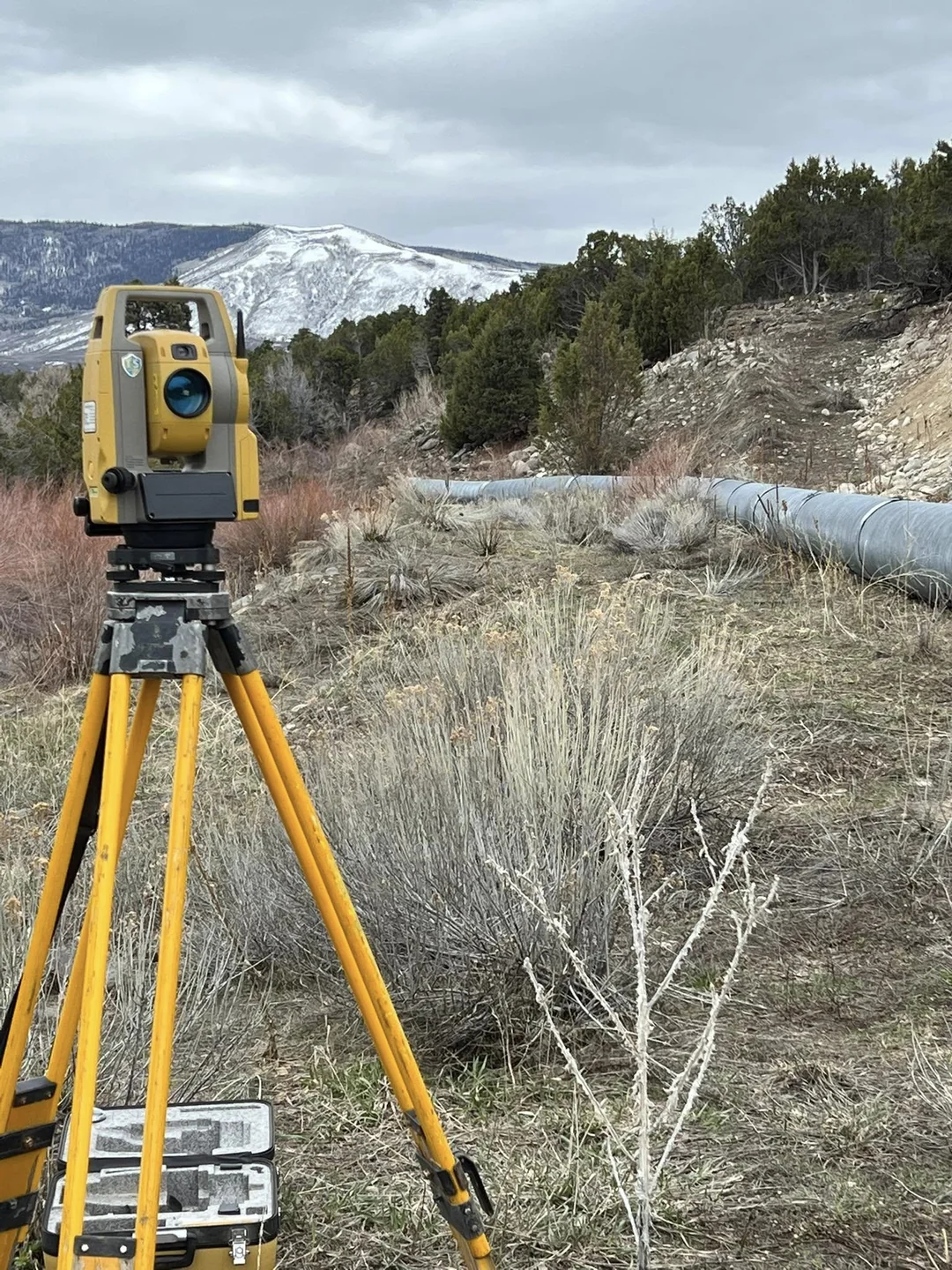 Surveying instrument on a tripod at an excavation site