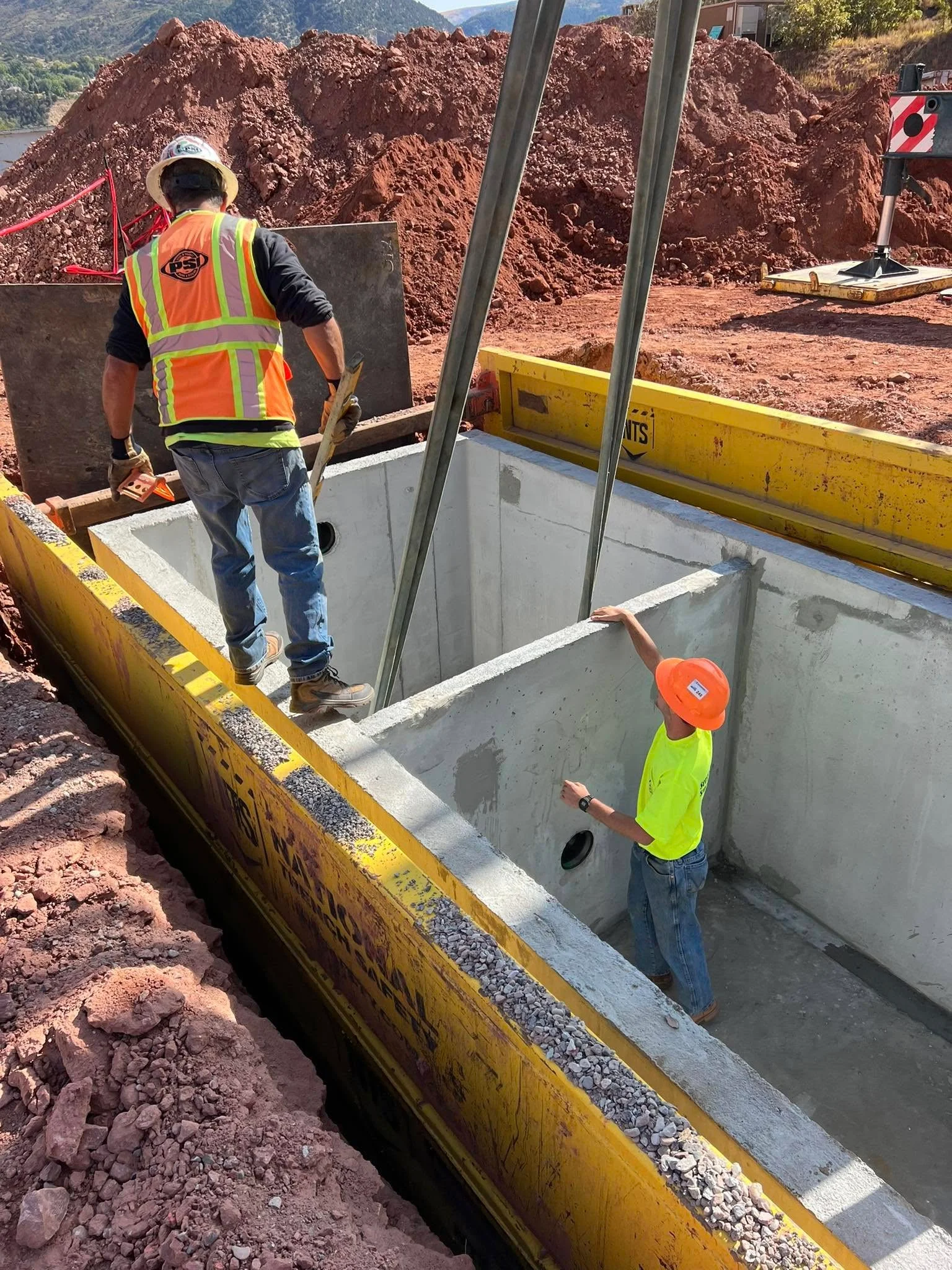 Crew member and equipment during a concrete tank installation