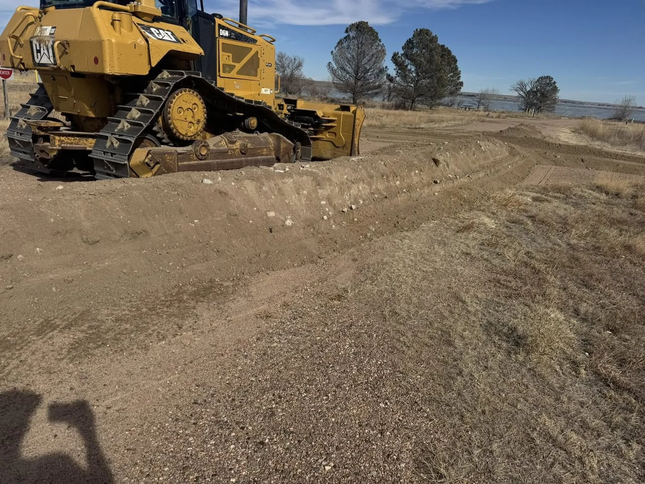 Tracked loader grading an open dirt site